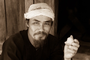 Vietnamese man eating a baguette